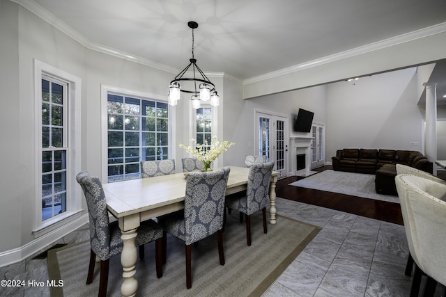 dining room with an inviting chandelier and ornamental molding