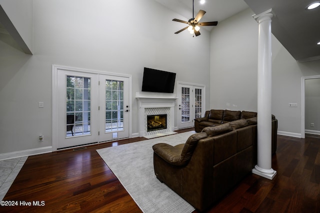 living room with high vaulted ceiling, french doors, ceiling fan, ornate columns, and dark hardwood / wood-style flooring