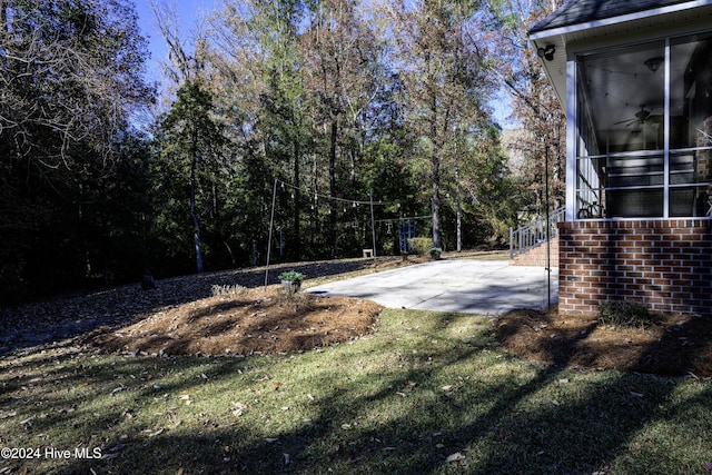 view of yard with ceiling fan and a patio area