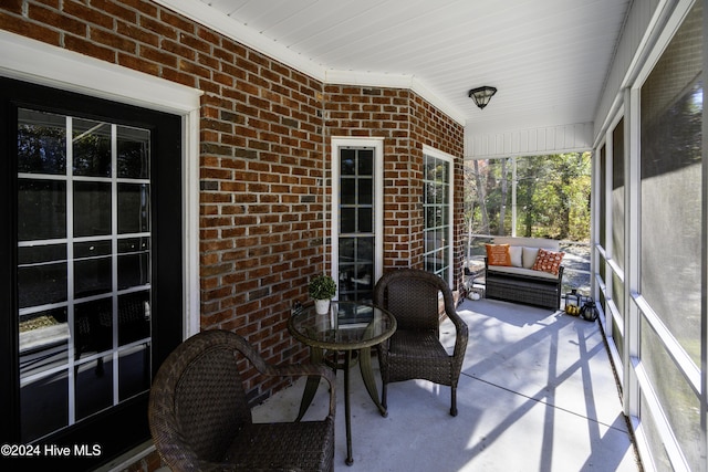 sunroom / solarium featuring lofted ceiling