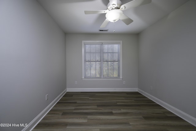 empty room with dark hardwood / wood-style flooring and ceiling fan