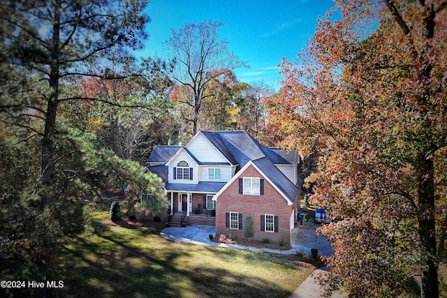 view of front of home with a front yard and a porch