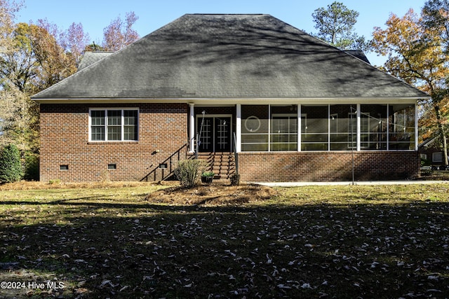 view of front facade featuring a front lawn and a sunroom