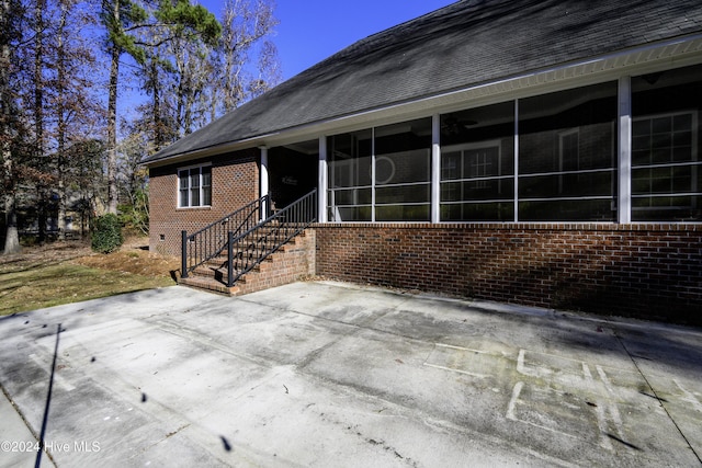 view of patio featuring a sunroom