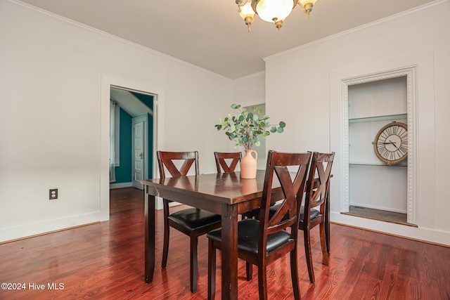 dining area with crown molding, dark hardwood / wood-style flooring, and a notable chandelier