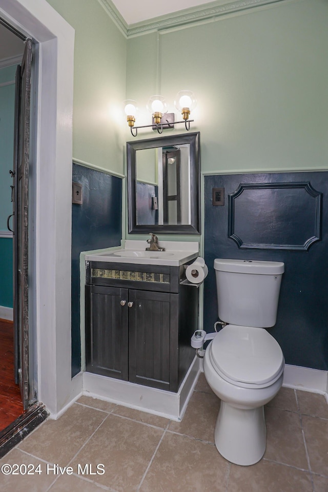 bathroom with crown molding, tile patterned flooring, vanity, and toilet