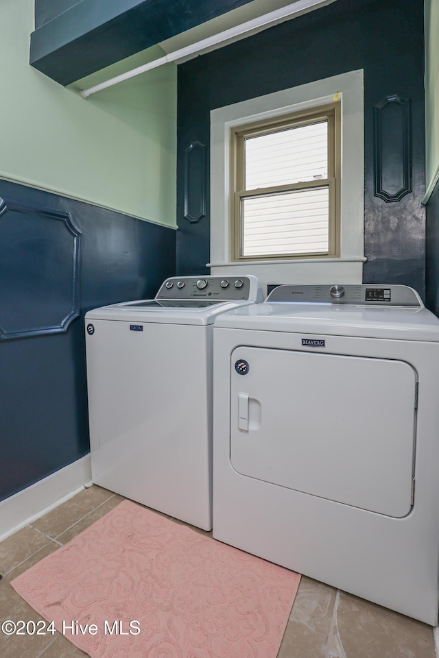 laundry area featuring light tile patterned flooring and washer and dryer