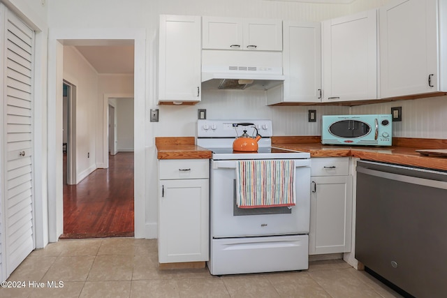 kitchen with butcher block countertops, ventilation hood, white appliances, and white cabinets