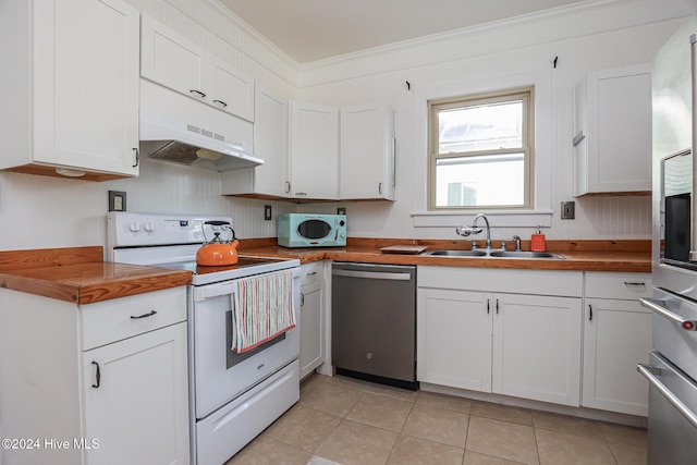 kitchen with wooden counters, appliances with stainless steel finishes, white cabinets, and sink