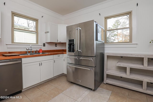 kitchen featuring white cabinets, a healthy amount of sunlight, sink, and stainless steel appliances