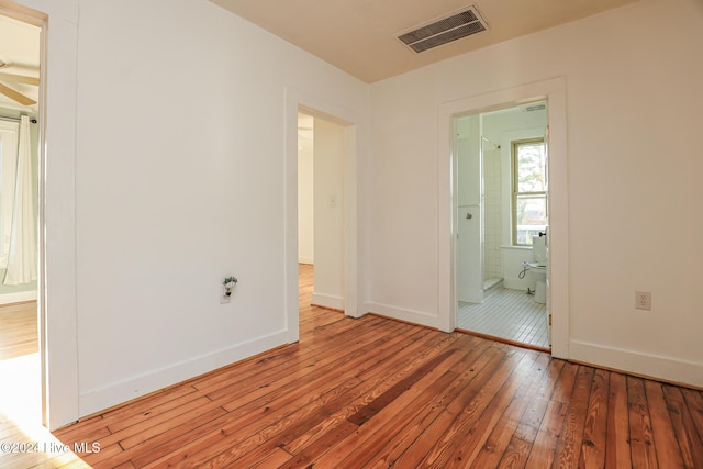 interior space featuring ensuite bath and hardwood / wood-style floors