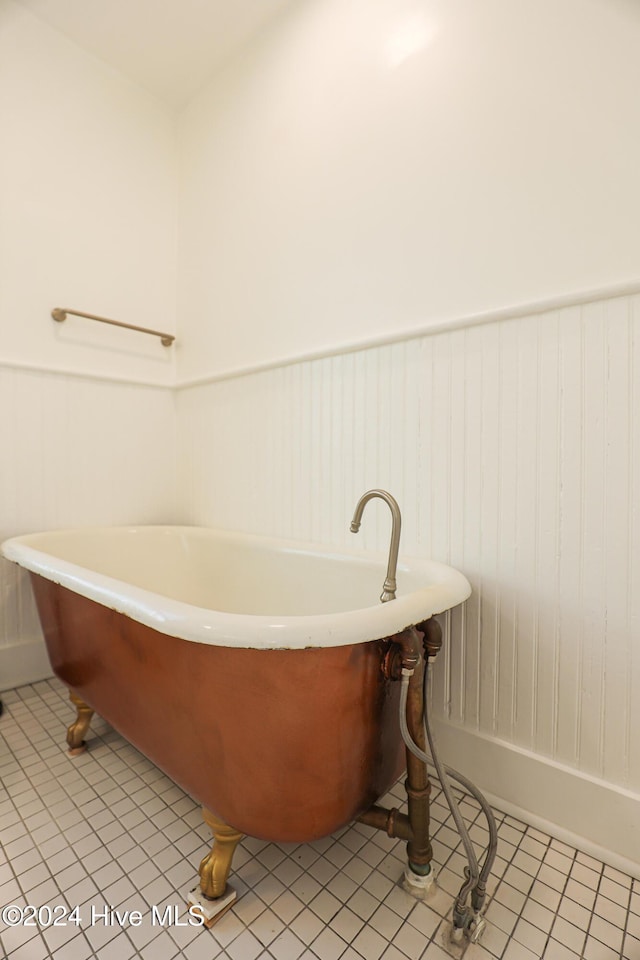 bathroom featuring tile patterned floors and a tub to relax in