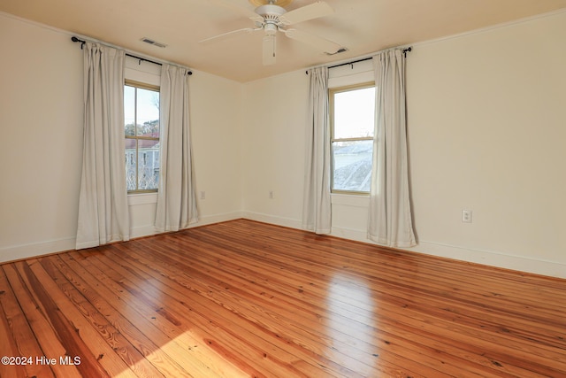 spare room featuring ceiling fan, plenty of natural light, and light wood-type flooring