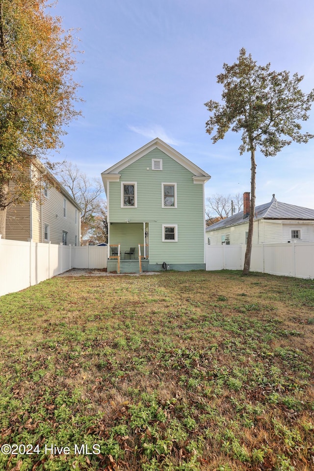 rear view of house with a yard