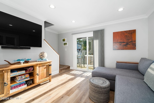 living room with hardwood / wood-style flooring and crown molding