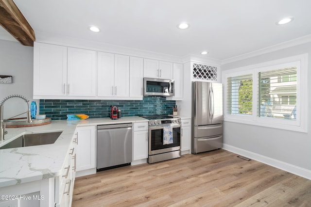 kitchen with white cabinetry, sink, stainless steel appliances, light stone counters, and light hardwood / wood-style floors