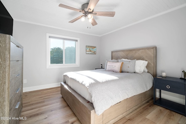 bedroom with light hardwood / wood-style floors, ceiling fan, and crown molding