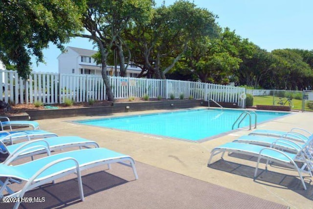 view of swimming pool with a patio area