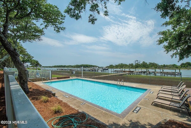 view of pool featuring a water view