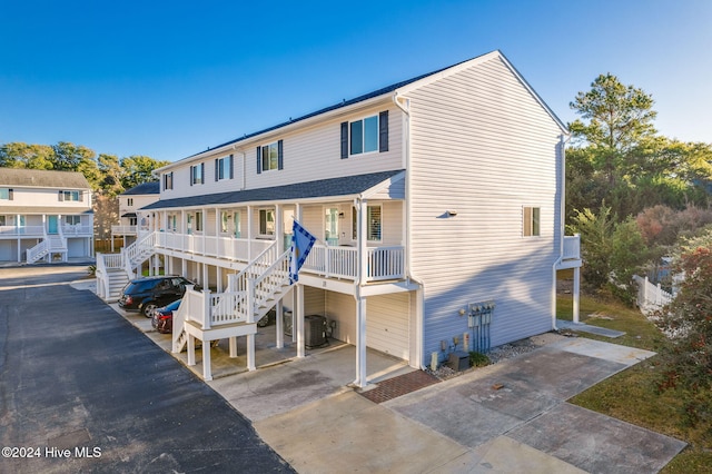 view of front of property with covered porch and central AC