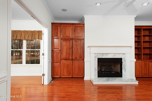 unfurnished dining area featuring ornamental molding, a chandelier, and hardwood / wood-style floors