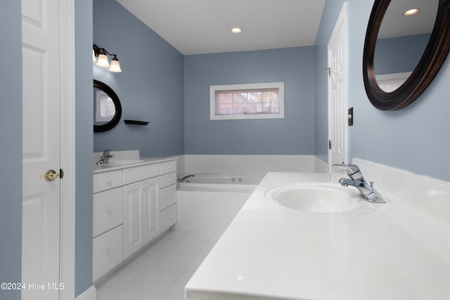 bathroom featuring vanity, tile patterned flooring, and tiled tub