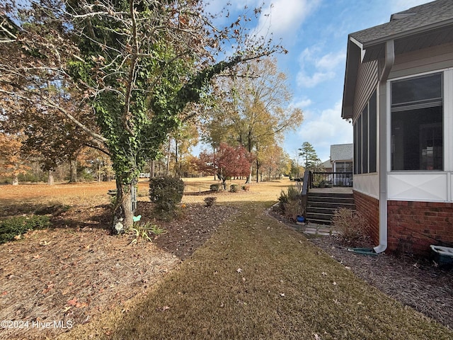 view of yard featuring a sunroom