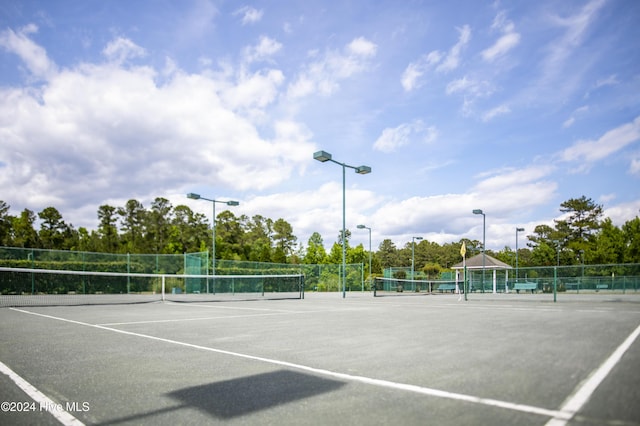 view of sport court featuring fence and a gazebo