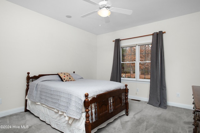 bedroom featuring light carpet, visible vents, and baseboards