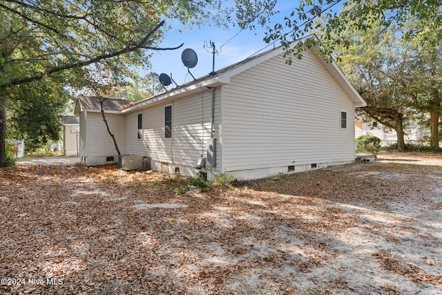 view of side of property with central AC