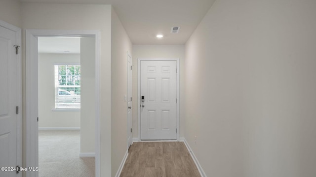 hall with light hardwood / wood-style flooring