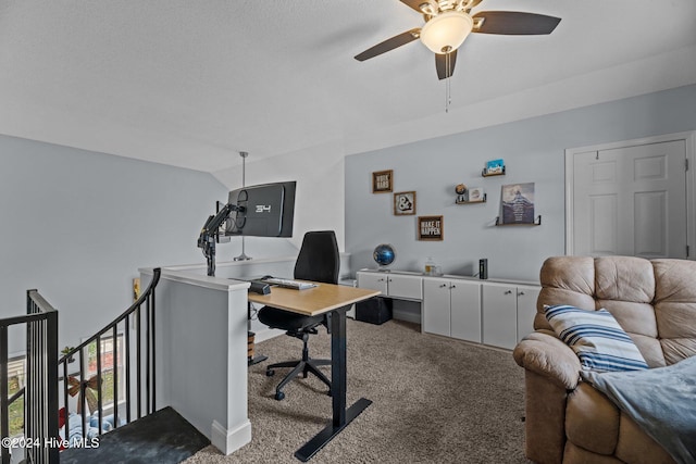 carpeted home office featuring ceiling fan, lofted ceiling, and a textured ceiling