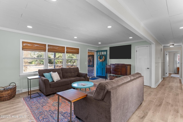 living room featuring ornamental molding and light hardwood / wood-style floors