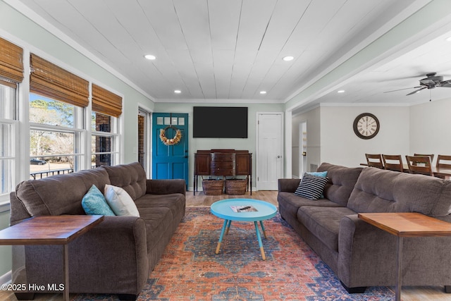 living room featuring wood ceiling, ceiling fan, ornamental molding, and wood-type flooring