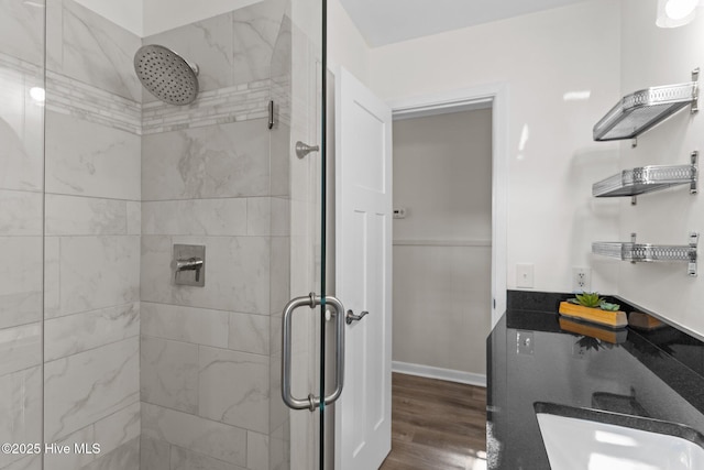 bathroom with hardwood / wood-style floors and a shower with door