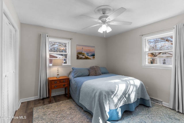 bedroom with wood-type flooring, ceiling fan, and a closet