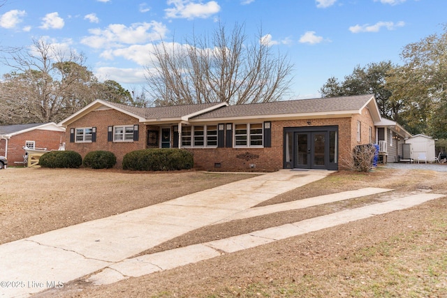 single story home featuring a shed and french doors