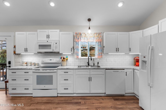 kitchen featuring sink, pendant lighting, white cabinets, and white appliances