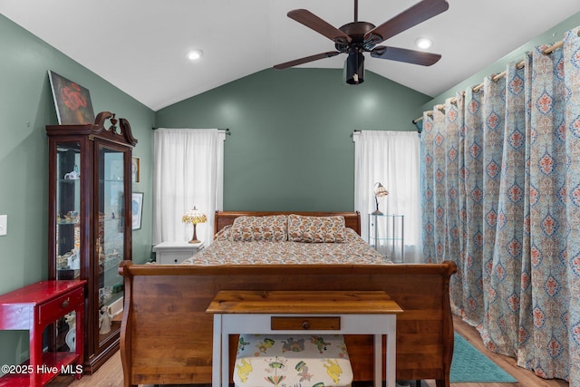 bedroom with lofted ceiling, light hardwood / wood-style flooring, and ceiling fan