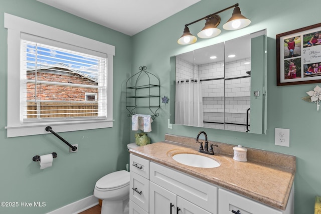 bathroom with vanity, toilet, and a shower with curtain