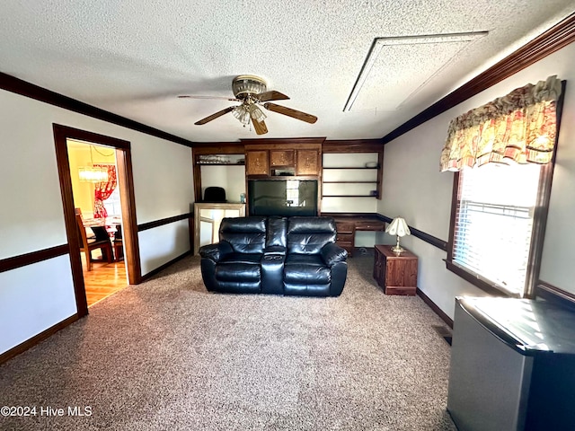 living room featuring a textured ceiling, carpet floors, ceiling fan, and crown molding