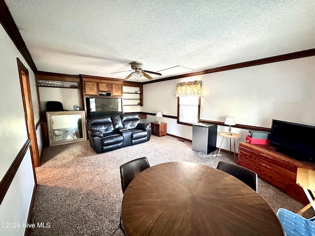 living room with ceiling fan, crown molding, light colored carpet, and a textured ceiling