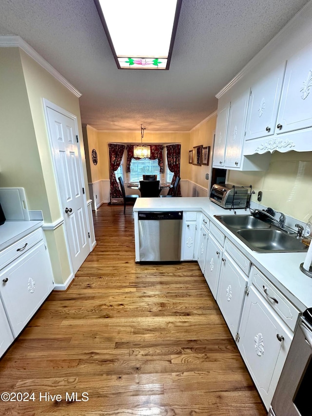 kitchen with white cabinetry, light hardwood / wood-style floors, decorative light fixtures, and appliances with stainless steel finishes