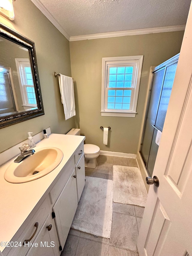 bathroom with vanity, crown molding, tile patterned flooring, a textured ceiling, and an enclosed shower