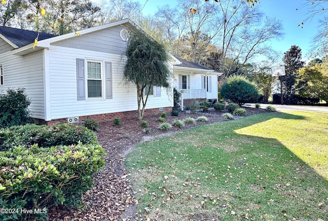 view of front of home with a front yard and a porch