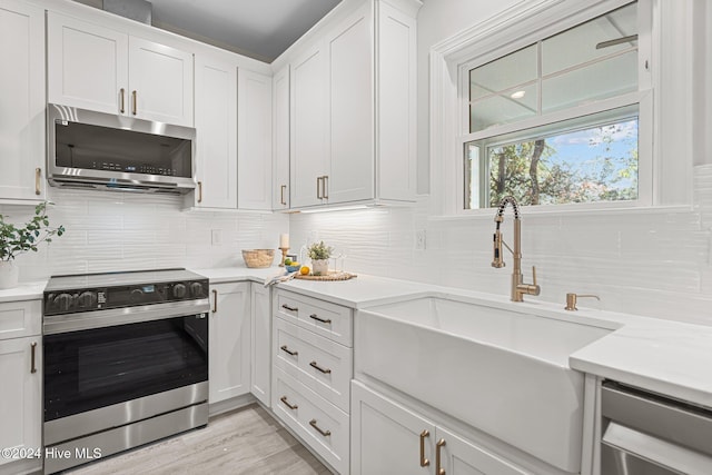 kitchen with white cabinets, a kitchen island, and sink