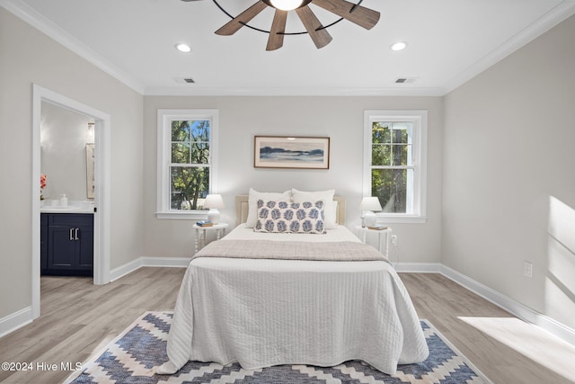 bedroom with light wood-type flooring, ensuite bathroom, ceiling fan, and ornamental molding