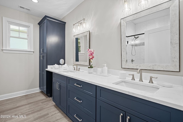 bathroom featuring a shower with door and wood-type flooring