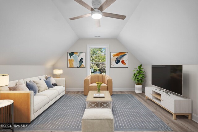 living room with ceiling fan, dark hardwood / wood-style flooring, and vaulted ceiling