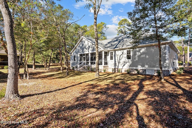 rear view of property with a sunroom